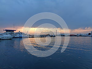 Ships at the pier in seaport at sunset