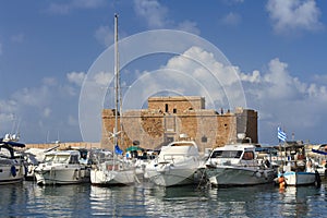 Ships in port on the background of the fortress of Paphos Cyprus