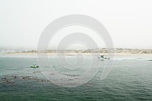 Ships, sailing boats and kayaks at Morro Bay harboar, California Coastline