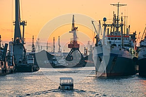 Ships in sea port on sunset background