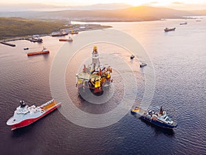 Ships are transporting offshore oil rig for installation sea for repairs, aerial top view