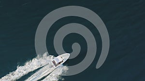Ships wake, top view. Aerial drone shot over the boat. Foam trail with waves