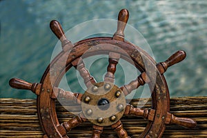 Ships Wheel Against Ocean Water