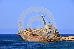 Shipwreck of the abandoned ship Edro III on a rocky coast at Akrotiri Beach in Cyprus