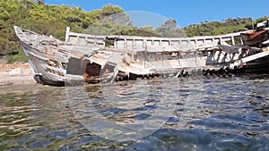 shipwreck on the beach of agal?pa of skyros island in greece pine trees clear transparent water in the sea