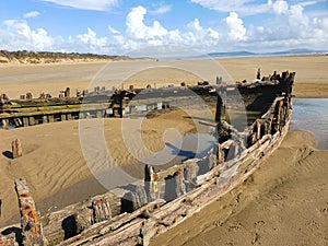 Shipwreck on the Cefn Sands beach at Pembrey Country Park in Carmarthenshire South Wales photo