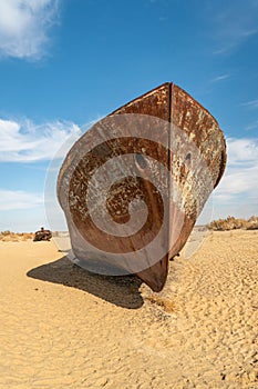 shipwreck. Ecological disaster of Aral Sea. Rusty ships at the ship graveyard in Aral sea port town Moynaq, Uzbekistan