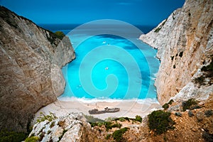 Shipwreck in Navagio beach. Azure turquoise sea water and paradise sandy beach. Famous tourist visiting landmark on