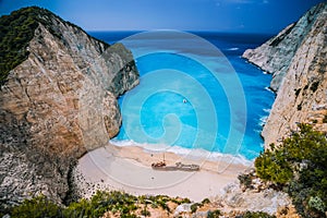 Shipwreck in Navagio beach. Azure turquoise sea water and sandy beach. Famous tourist visiting landmark on Zakynthos