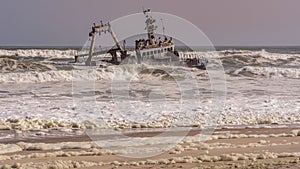 A shipwreck stranded on the beach in the Atlantic Ocean in the Skeleton Coast National Park in Namibia