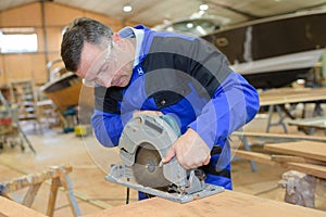 Shipwright cutting a plywood photo