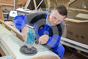 Shipwright polishing the frame photo