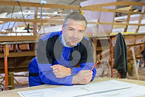 Shipwright posing in shipyard photo