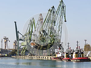 Shipyard cranes and tug boats in Varna , Bulgaria