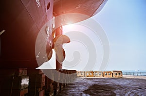 Shipyard ship moored in floating dry dock yard ship stern.