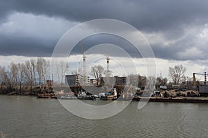 Shipyards Zaton in the Gulf of Novosibirsk Ob river Parking of ships and boats boat station under the stormy sky
