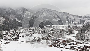 Shirakawago village with snow fall in winter season . Landmark of Gifu , Takayama , Japan . View point landscape