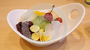 Shiratama Anmitsu is a classic Japanese sweet dumplings served with matcha ice cream, assorted fruits, ogura paste and topped with