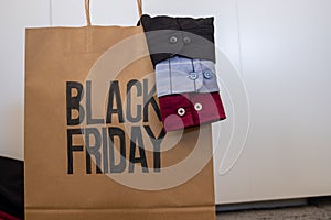 Shirt sleeve with shopping bag represents clothes sales for black friday and white friday with mock up space or free space