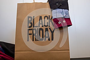 Shirt sleeve with shopping bag represents clothes sales for black friday and white friday with mock up space or free space