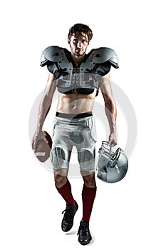 Shirtless American football player with padding holding ball and helmet photo