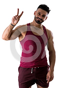 Shirtless bodybuilder doing Victory sign