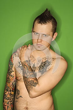 Shirtless Caucasian man with tattoos.