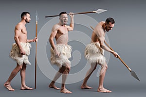 Of shirtless caveman with spear on