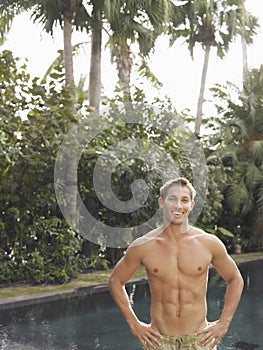 Shirtless Macho Man Smiling By Swimming Pool