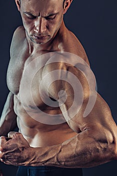 Shirtless male bodybuilder with muscular build strong abs showing. Shot of healthy muscular young man. Perfect fit, six