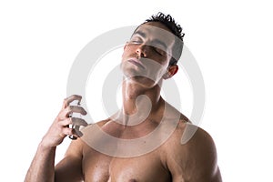 Shirtless male model spraying cologne