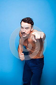 Shirtless man with beard on blue background