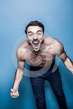 Shirtless man with beard on blue background