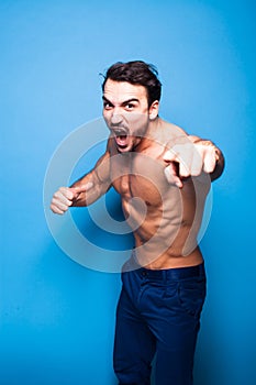 Shirtless man with beard on blue background