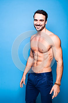 Shirtless man with beard on blue background