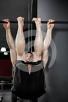 Shirtless man doing pull up