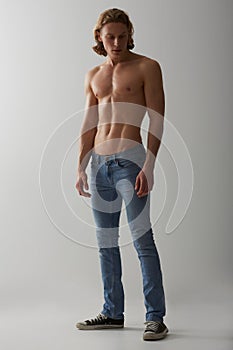 Shirtless, model and man in jeans on studio, white background and mockup with fashion. Male, beauty and handsome topless