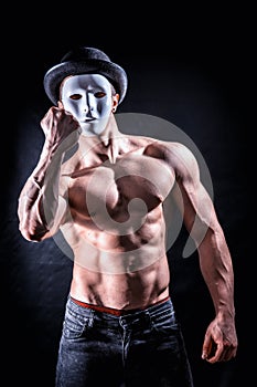 Shirtless muscle man with creepy, scary mask