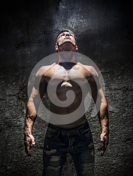 Shirtless Muscle Man Looking Up Into Bright Overhead Light