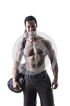 Shirtless muscular black young man with gym bag
