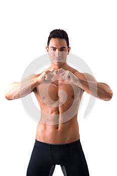 Shirtless muscular man making heart sing with