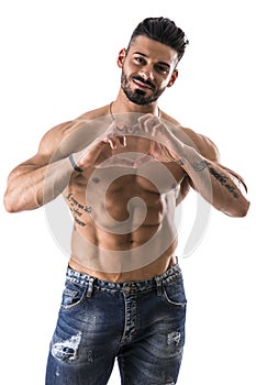 Shirtless muscular man making heart sing with hands