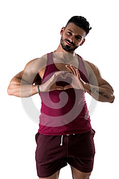 Shirtless muscular man making heart sing with hands