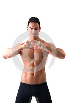 Shirtless muscular man making heart sing with hands