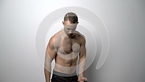 Shirtless muscular man training with Resistance Band