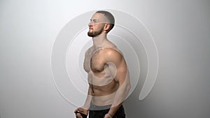 Shirtless muscular man training with Resistance Band