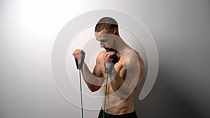 Shirtless muscular man training with Resistance Band