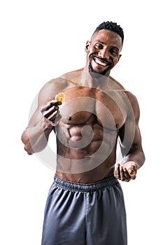 Shirtless muscular young man eating rice cracker