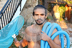 Shirtless pool boy with tools