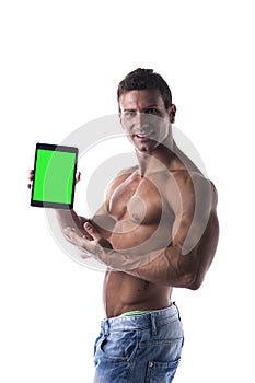 Shirtless young male bodybuiler holding ebook reader or tablet PC photo